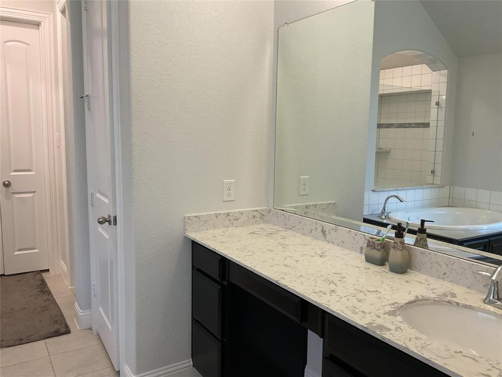 2805 Newsom Ridge Drive Mansfield, TX 76063 - Photo 25 of 33 a bathroom with a granite countertop sink and a mirror