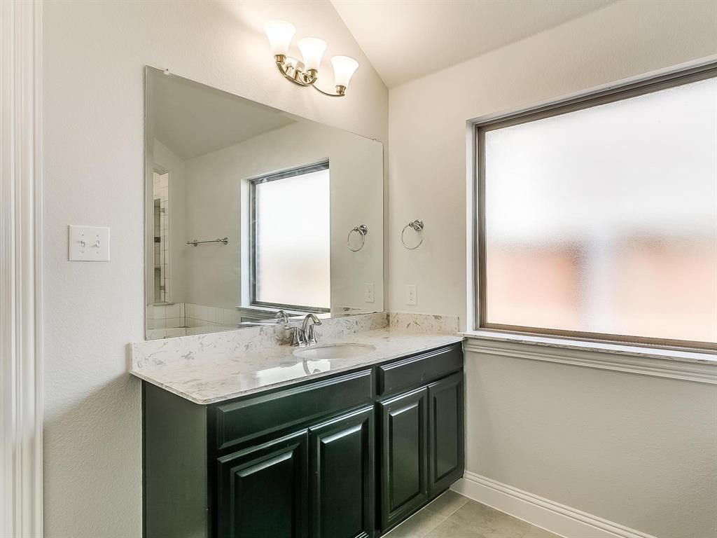 2805 Newsom Ridge Drive Mansfield, TX 76063 - Photo 27 of 33 a bathroom with a sink and a mirror