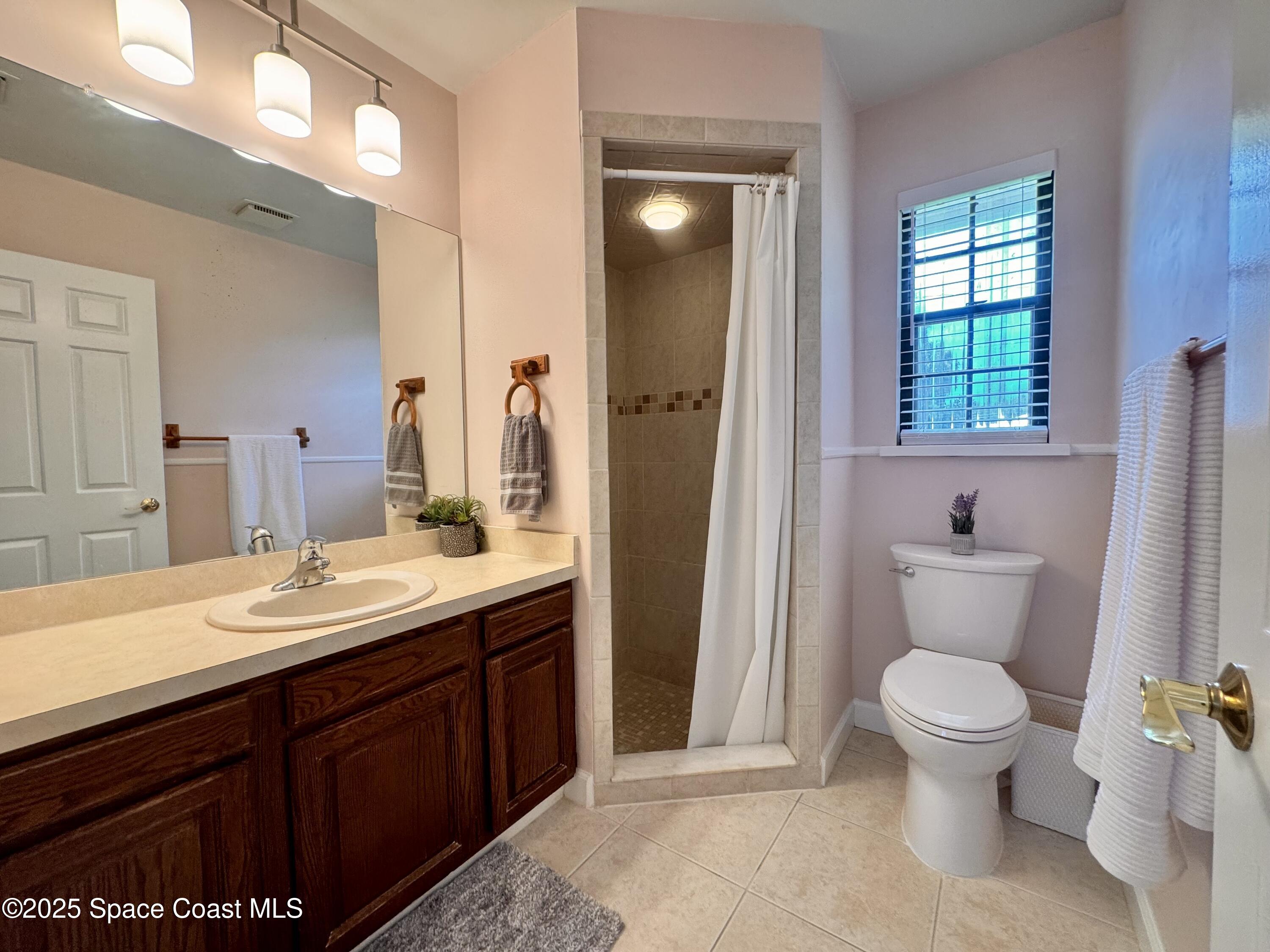 658 Ervin Street Sebastian, FL 32958 - Photo 20 of 36 a bathroom with a toilet sink and mirror