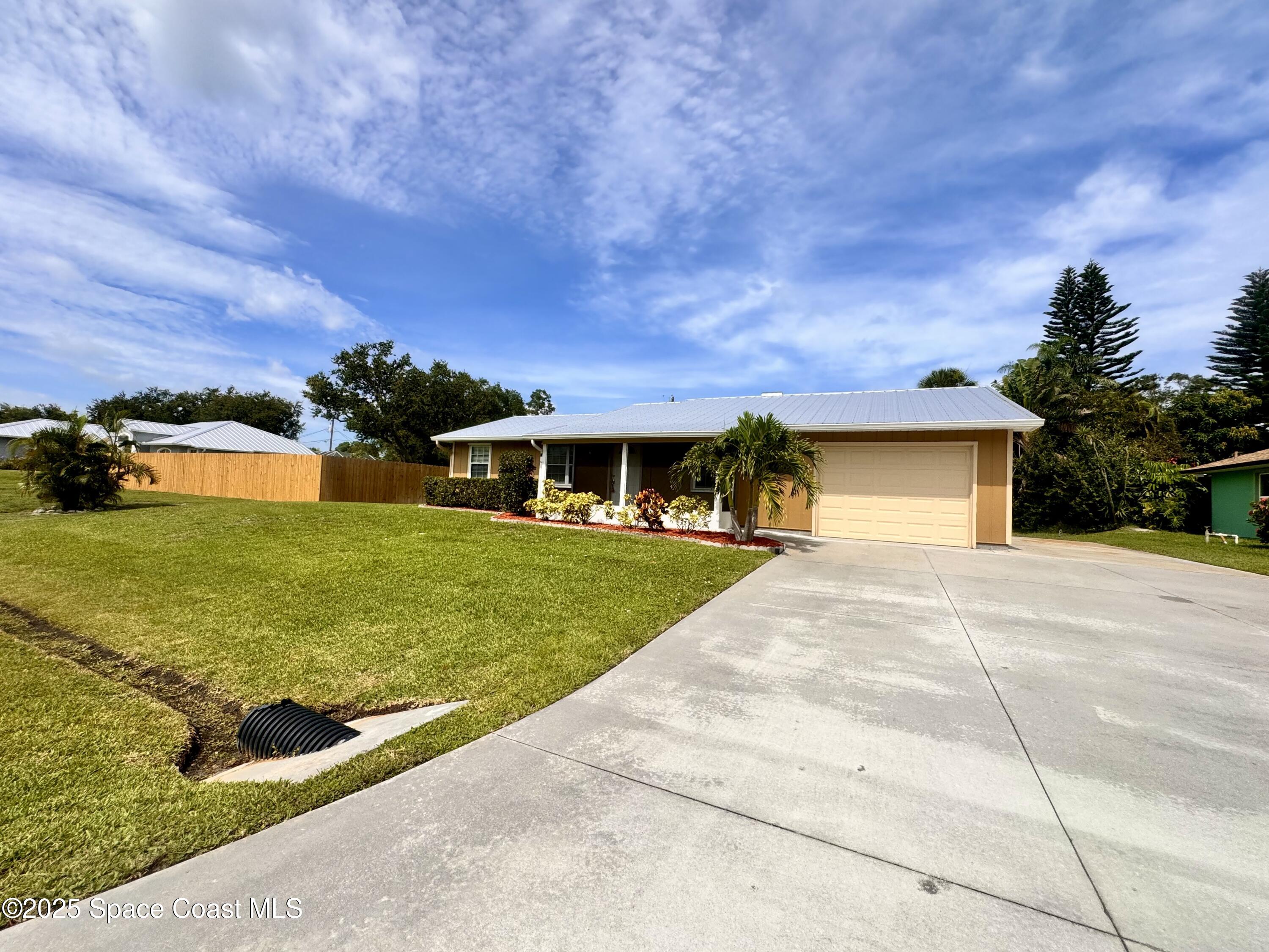 658 Ervin Street Sebastian, FL 32958 - Photo 2 of 36 a front view of a house with a yard