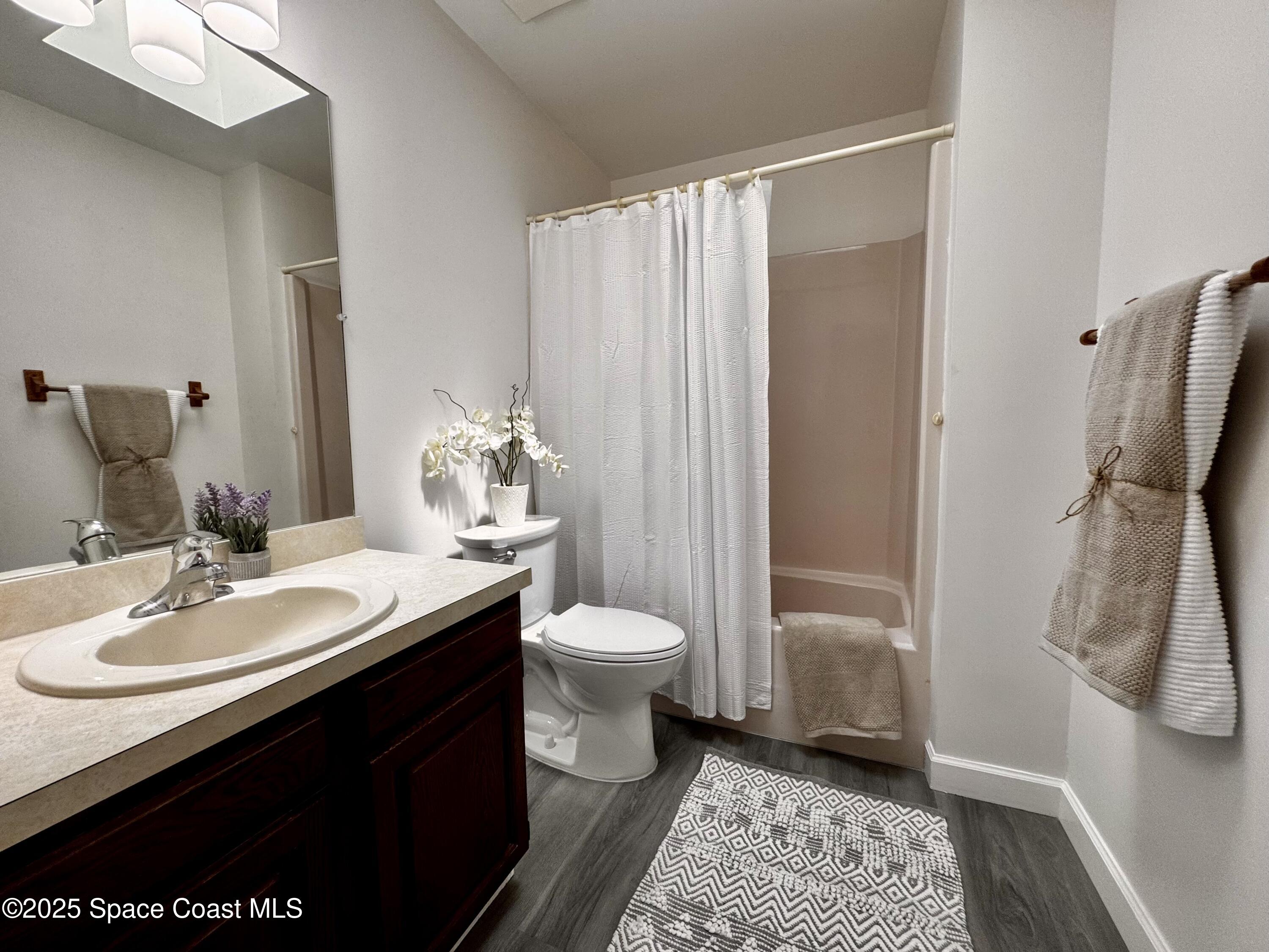 658 Ervin Street Sebastian, FL 32958 - Photo 23 of 36 a bathroom with a granite countertop sink toilet and shower