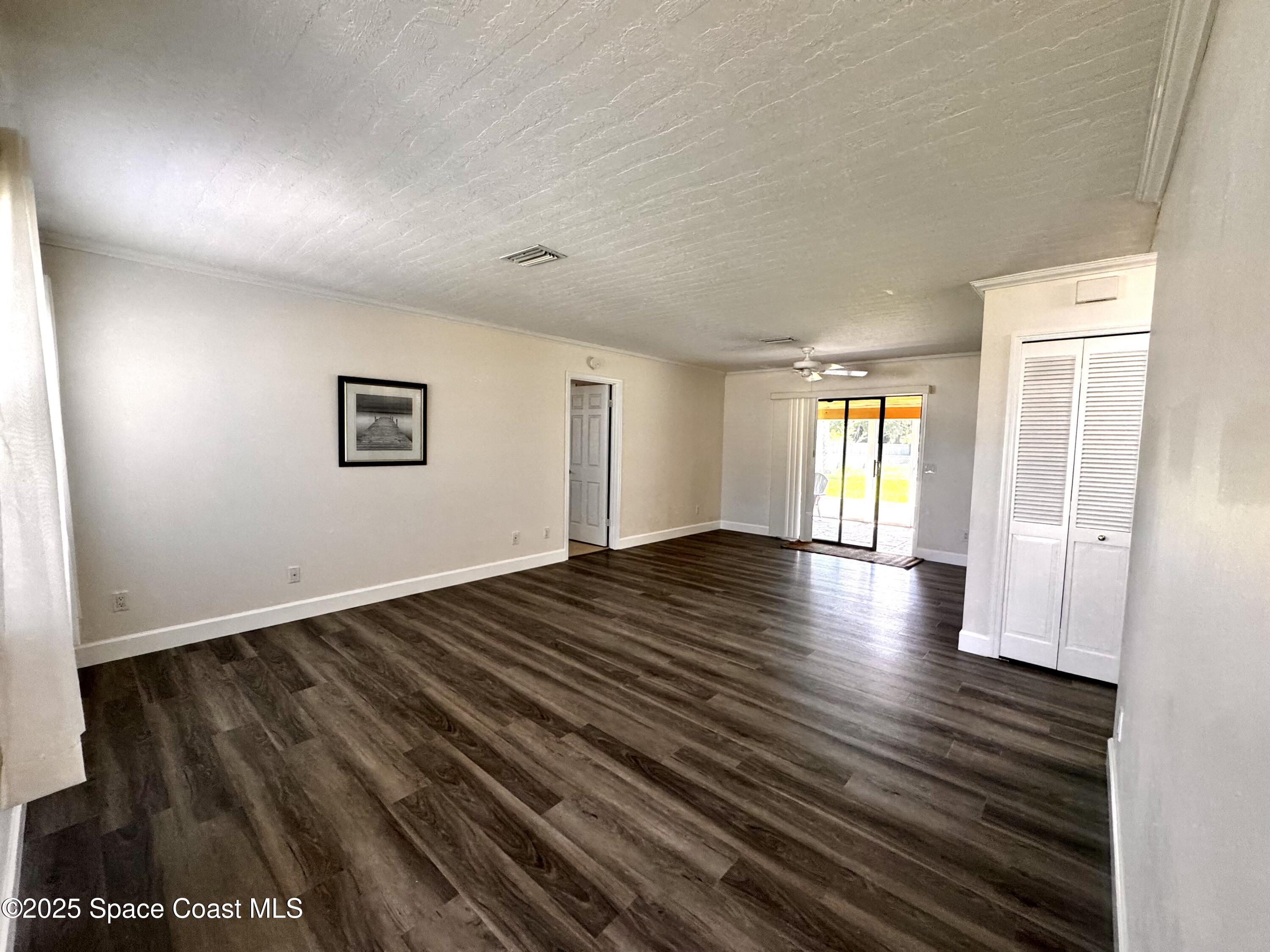 658 Ervin Street Sebastian, FL 32958 - Photo 9 of 36 a view of a livingroom with wooden floor