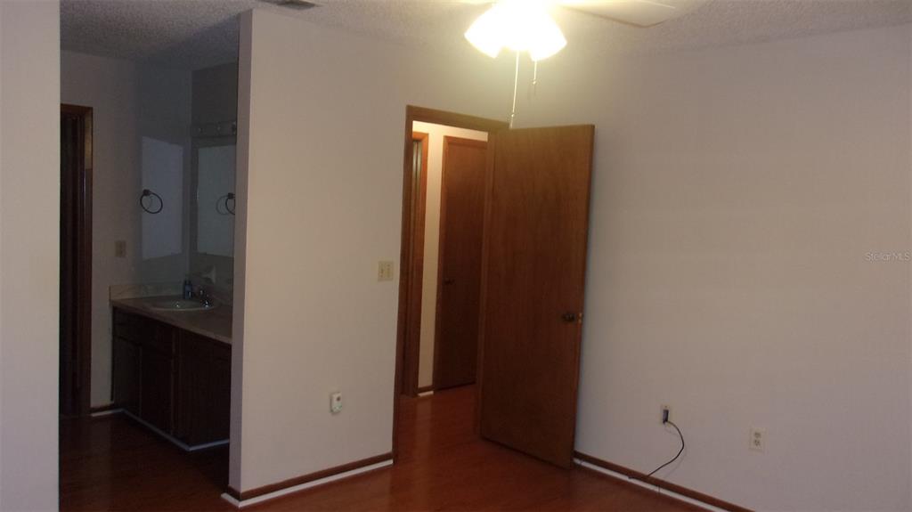10015 Southwest 90th Court Ocala, FL 34481 - Photo 11 of 48 an empty room with wooden floor sink and closet