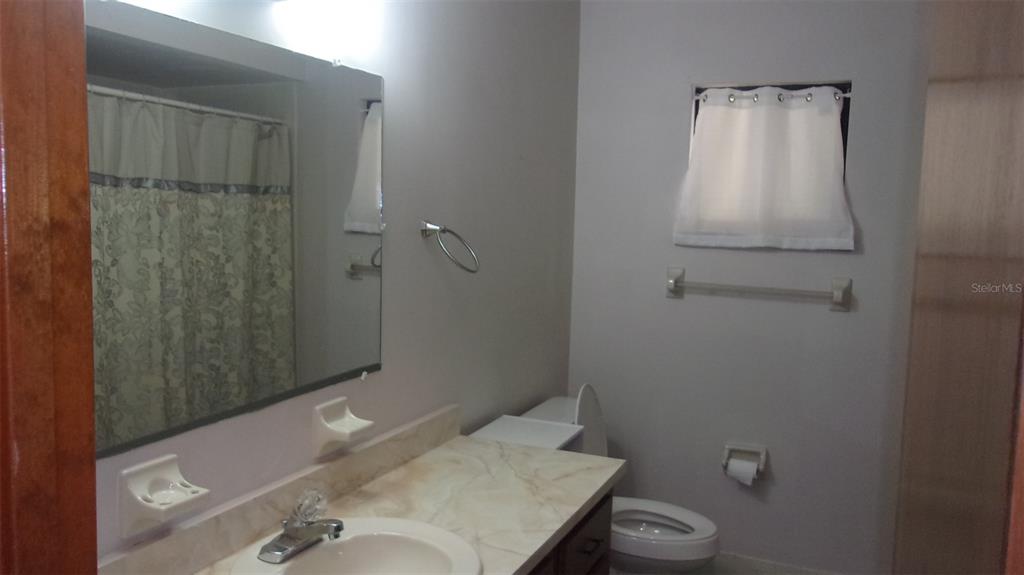 10015 Southwest 90th Court Ocala, FL 34481 - Photo 14 of 48 a bathroom with a sink and toilet