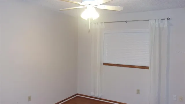 a small space with a window and a fan