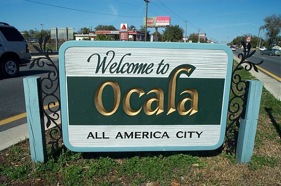 10015 Southwest 90th Court Ocala, FL 34481 - Photo 43 of 48 a sign that is on a street sign