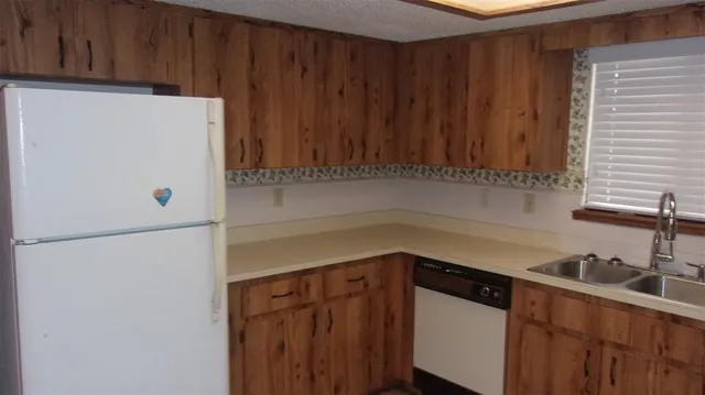a white refrigerator freezer sitting inside of a kitchen