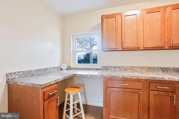 a kitchen with granite countertop cabinets and window