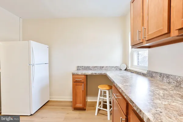 a view of a kitchen with wooden floor and cabinets