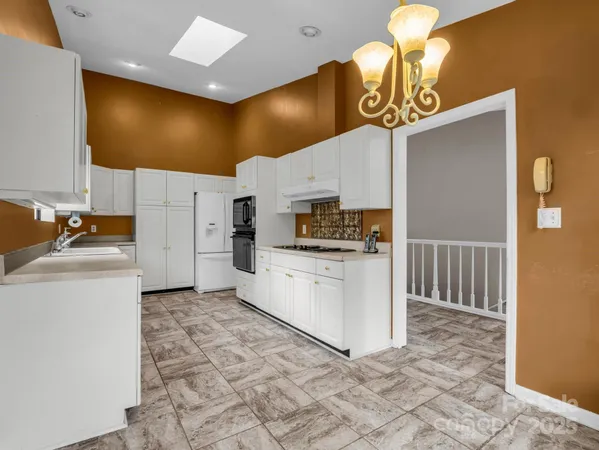 a kitchen with a sink appliances and cabinets
