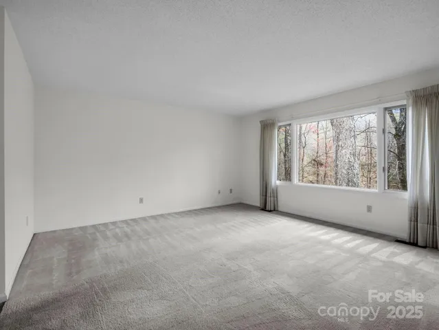 an empty room with large windows