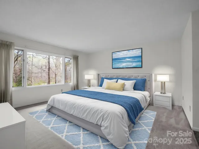 a bedroom with a large bed and a large window