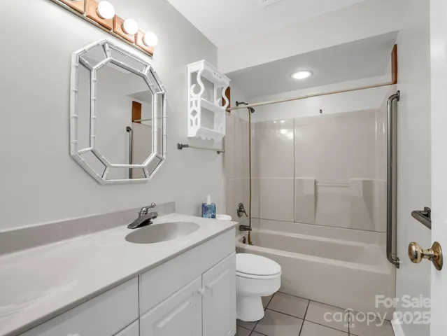 a bathroom with a sink toilet a mirror and shower