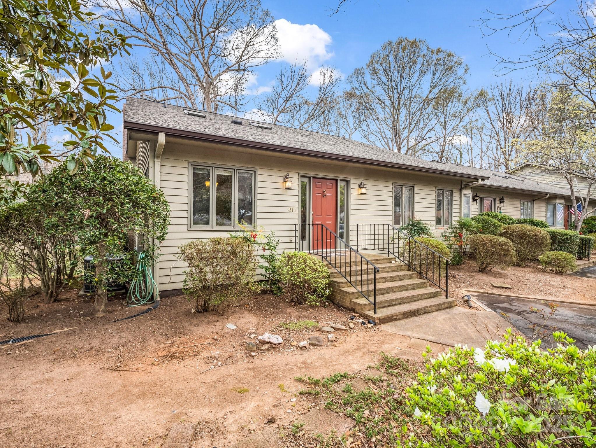 31 Hunting Country Trail Tryon, NC 28782 - Photo 39 of 40 a front view of a house with garden