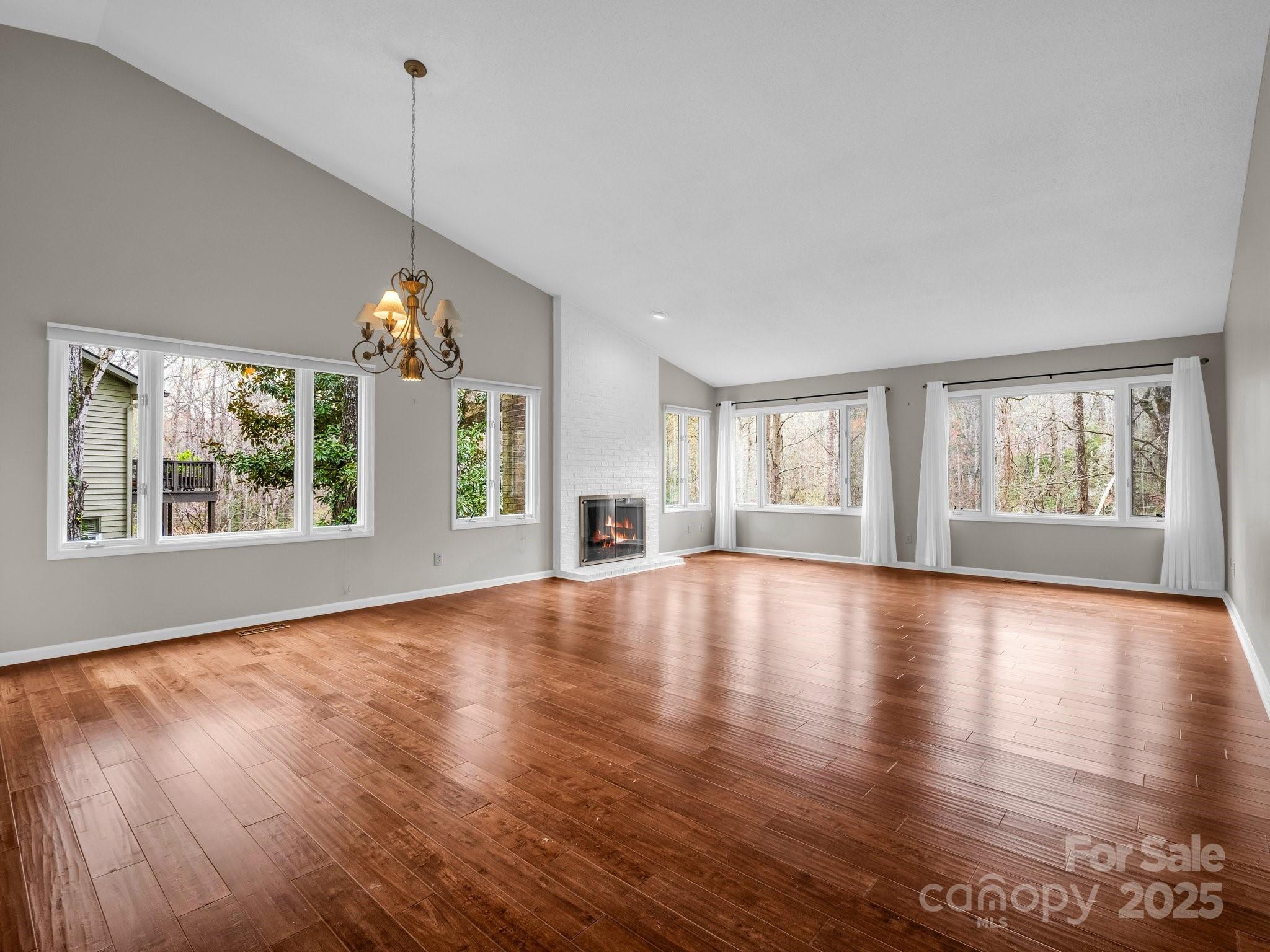31 Hunting Country Trail Tryon, NC 28782 - Photo 4 of 40 a view of an empty room with wooden floor and a window