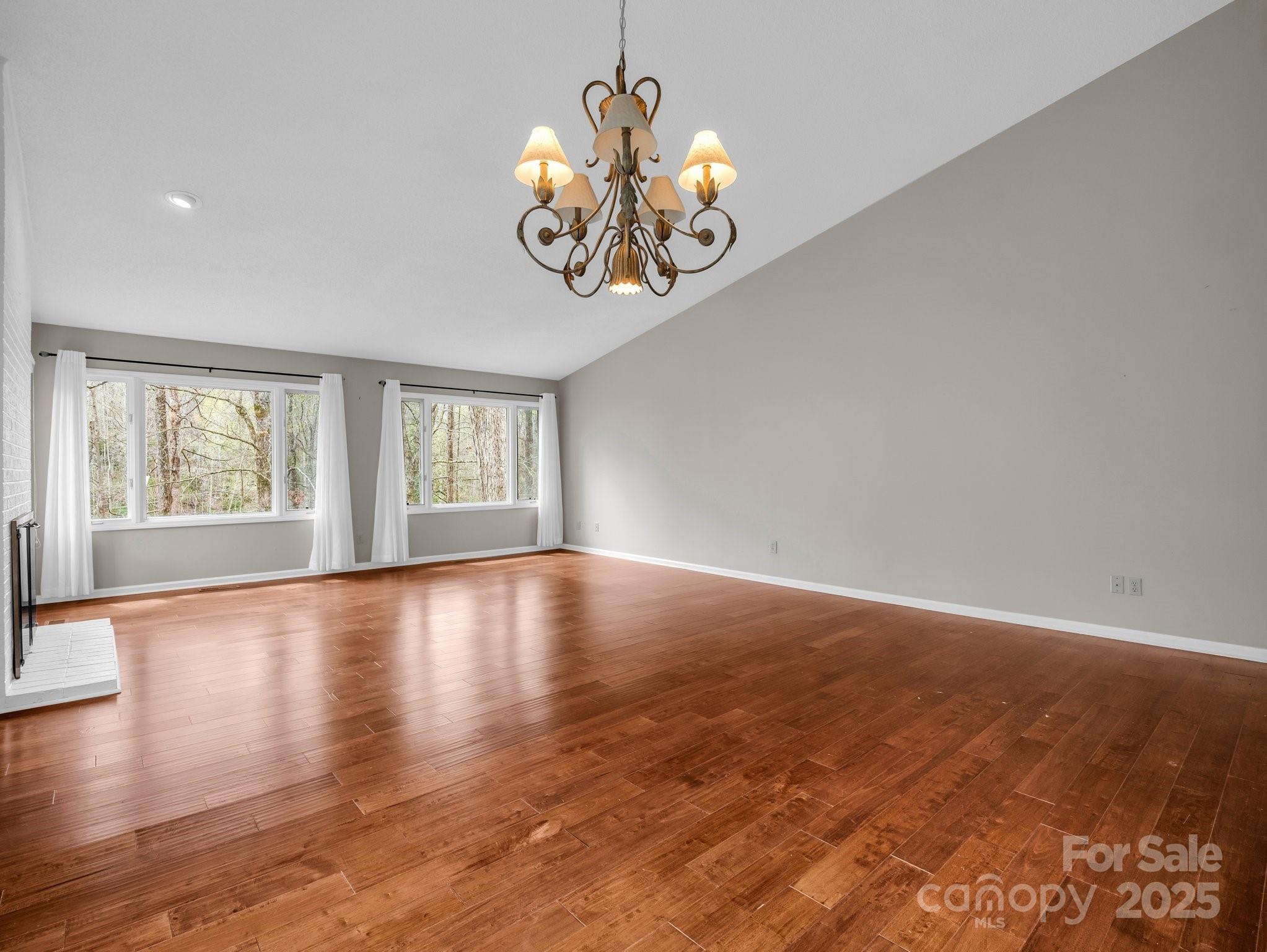 31 Hunting Country Trail Tryon, NC 28782 - Photo 5 of 40 an empty room with wooden floor and windows