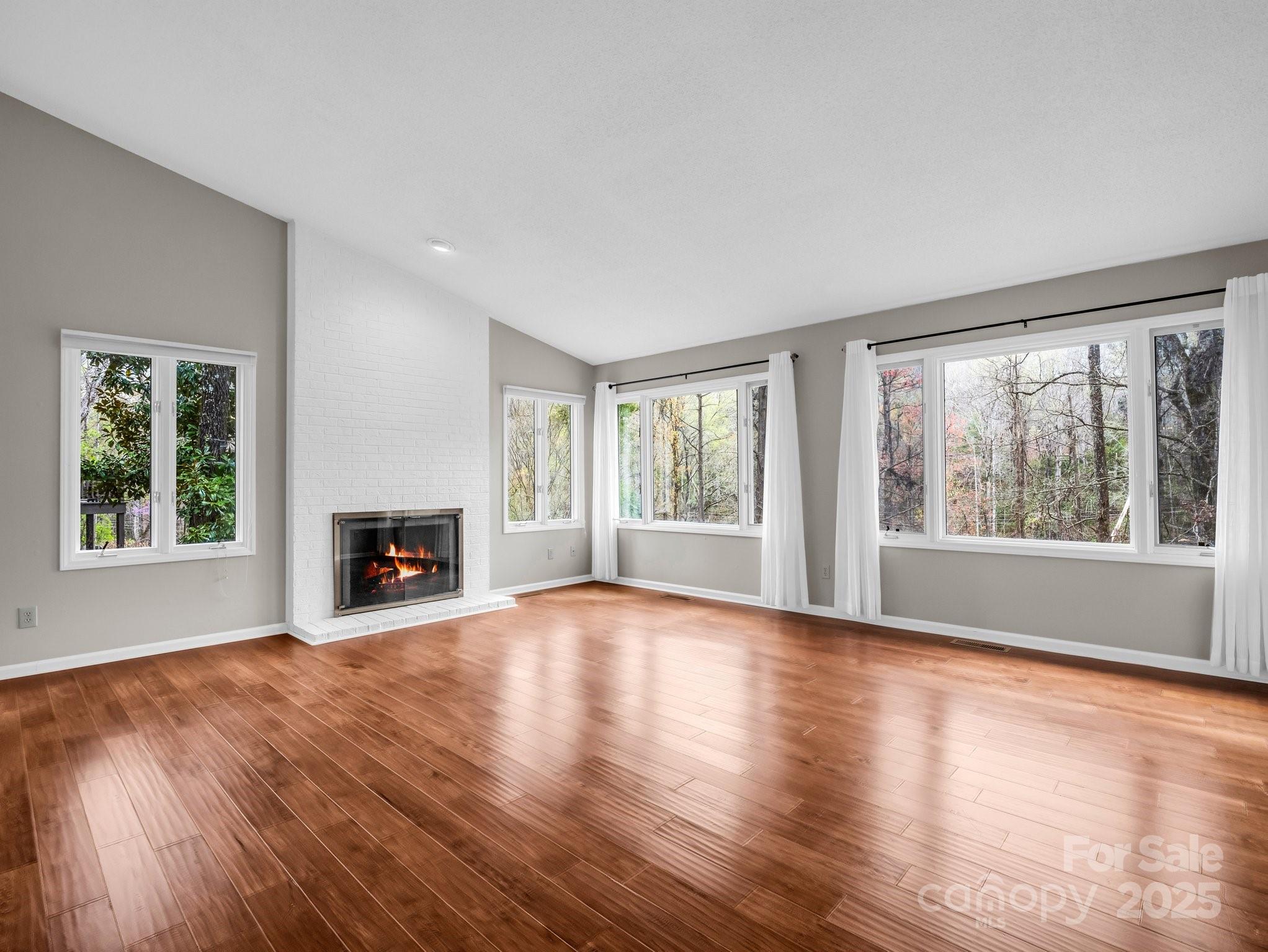 31 Hunting Country Trail Tryon, NC 28782 - Photo 8 of 40 a view of an empty room with wooden floor and a window