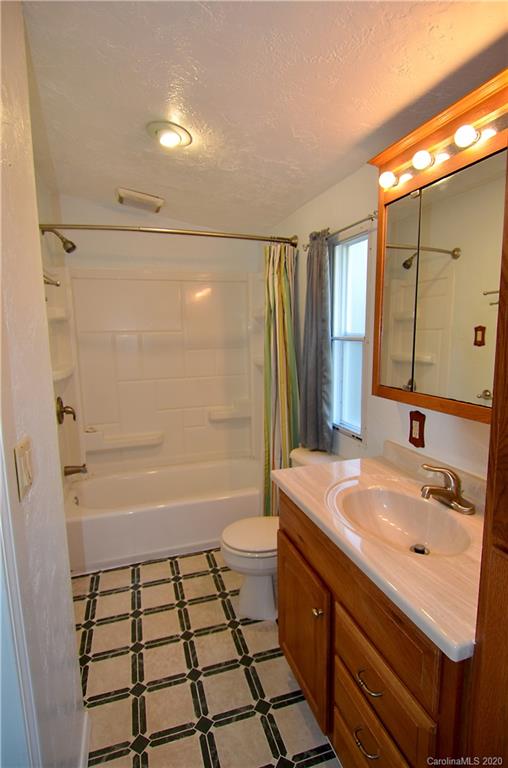 358 Toney Road Marion, NC 28752 - Photo 12 of 21 a bathroom with a sink a double vanity sink a mirror and a bathtub