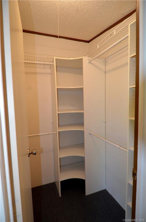 358 Toney Road Marion, NC 28752 - Photo 13 of 21 a view of walk in closet with empty racks