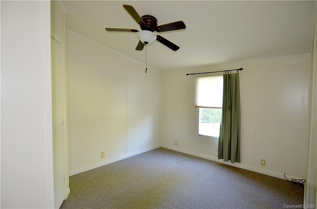 358 Toney Road Marion, NC 28752 - Photo 15 of 21 an empty room with a window and a ceiling fan
