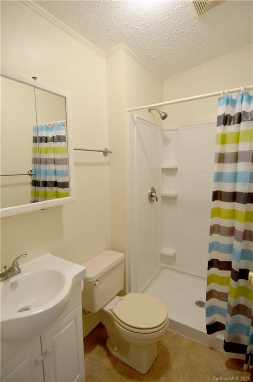 358 Toney Road Marion, NC 28752 - Photo 16 of 21 a bathroom with a sink toilet and shower
