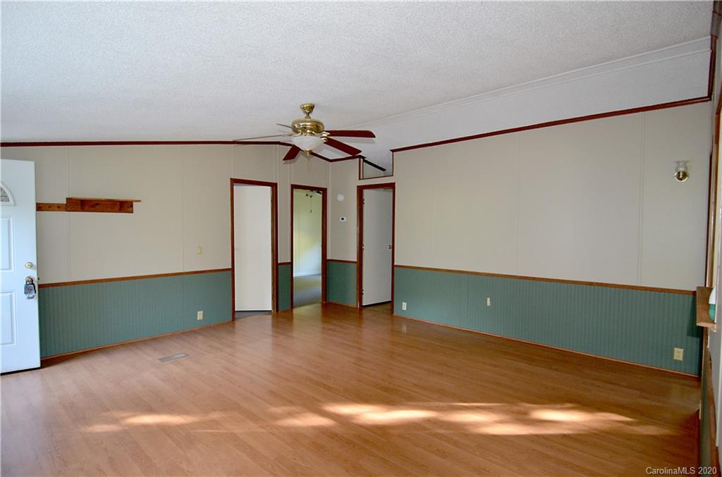 358 Toney Road Marion, NC 28752 - Photo 7 of 21 a view of an empty room with wooden floor and a window