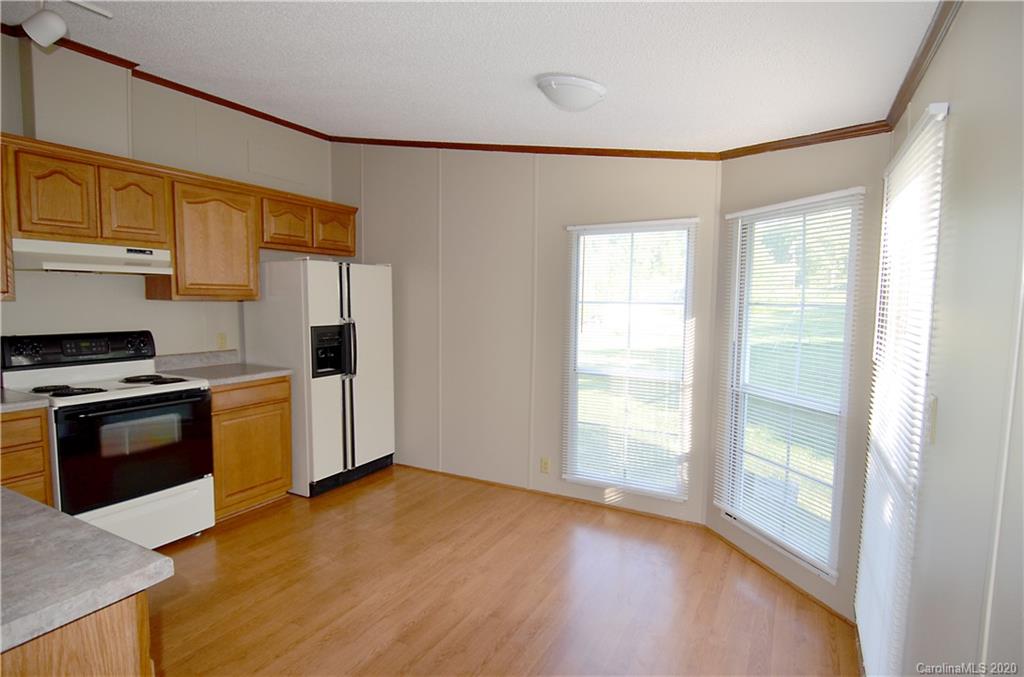 358 Toney Road Marion, NC 28752 - Photo 9 of 21 a kitchen with a wooden floor and a stove top oven