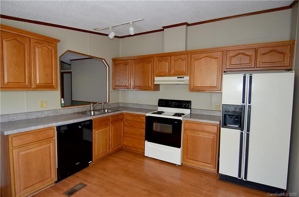 358 Toney Road Marion, NC 28752 - Photo 10 of 21 a kitchen with stainless steel appliances granite countertop a refrigerator a sink dishwasher a stove and a microwave oven on granite countertops