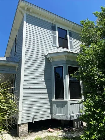 a front view of a house with plants