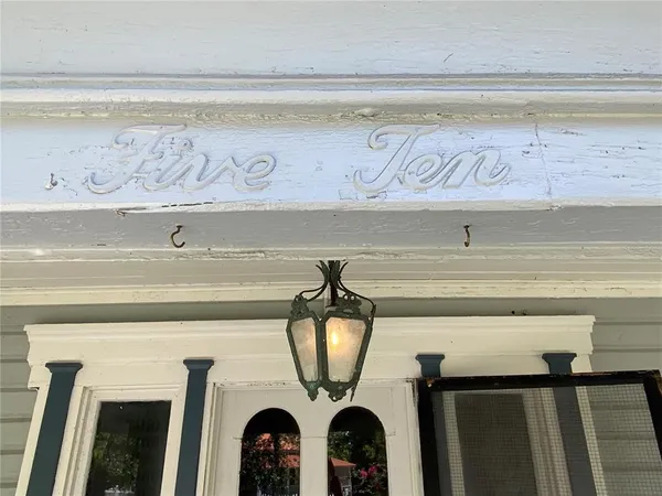 a view of a house with a door and wooden fence