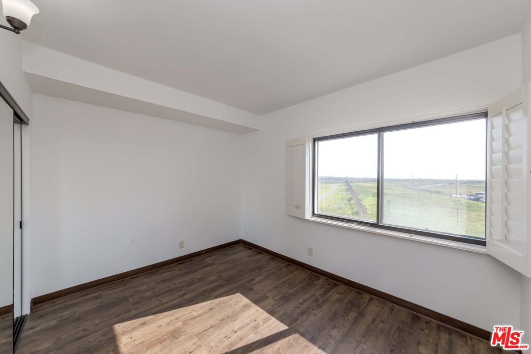 8180 Manitoba Street, Unit 248 Playa del Rey, CA 90293 - Photo 16 of 40 an empty room with wooden floor and windows
