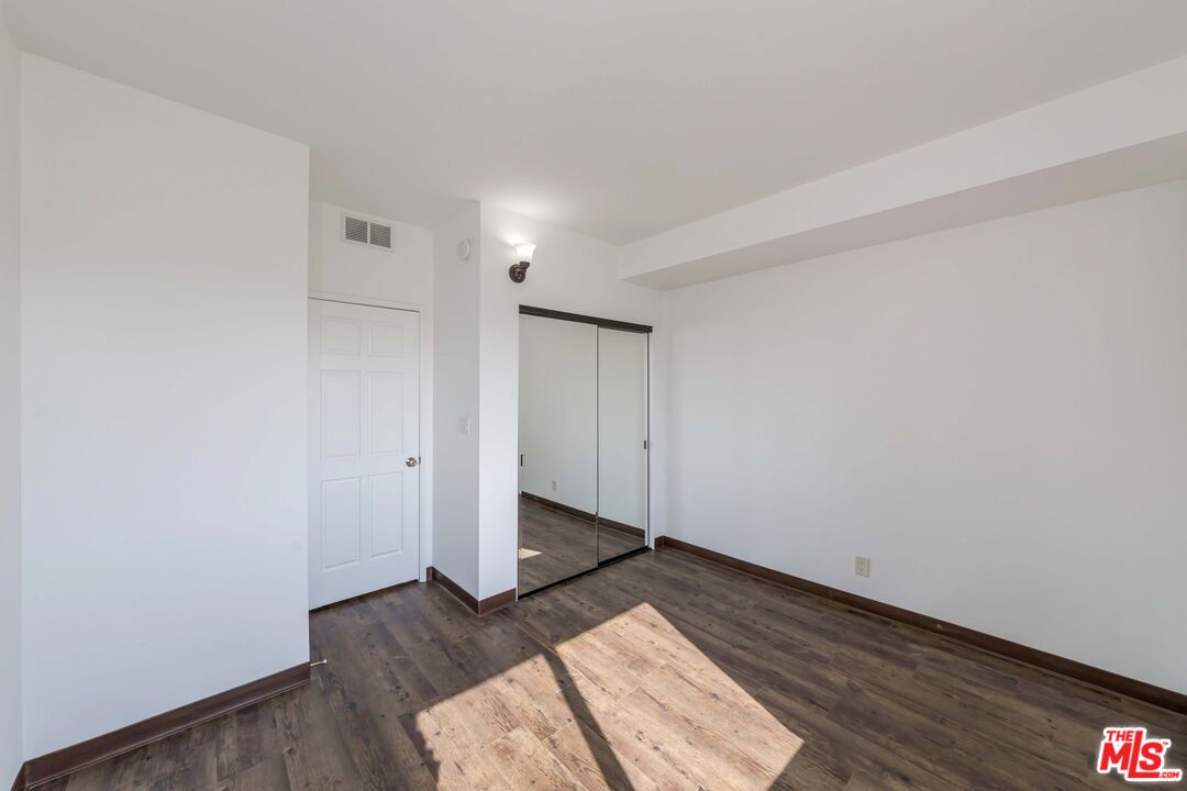 8180 Manitoba Street, Unit 248 Playa del Rey, CA 90293 - Photo 18 of 40 an empty room with wooden floor