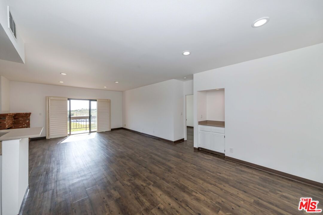 8180 Manitoba Street, Unit 248 Playa del Rey, CA 90293 - Photo 2 of 40 a view of empty room with wooden floor and fan