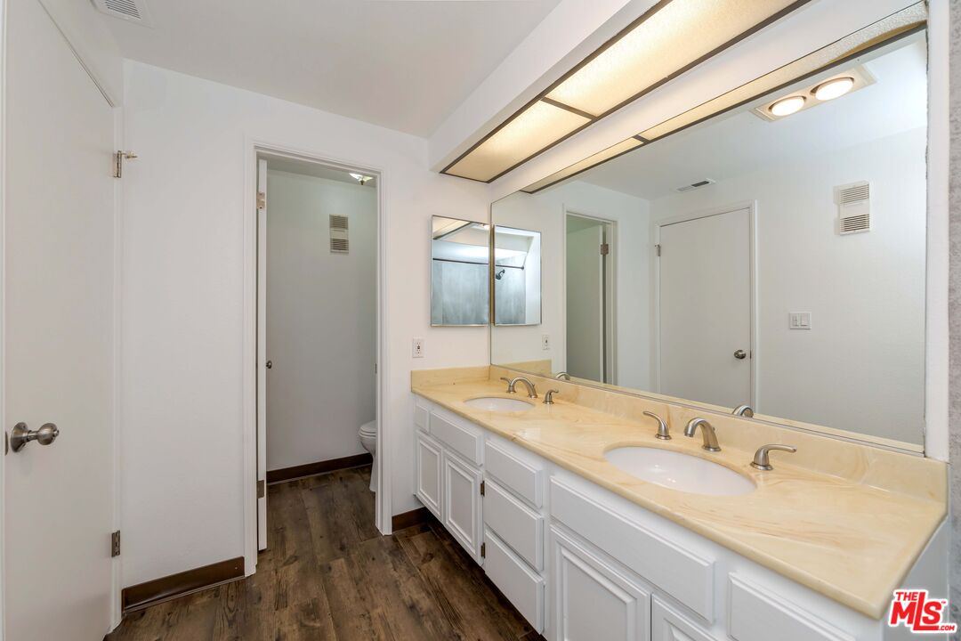 8180 Manitoba Street, Unit 248 Playa del Rey, CA 90293 - Photo 23 of 40 a spacious bathroom with a granite countertop sink and a mirror
