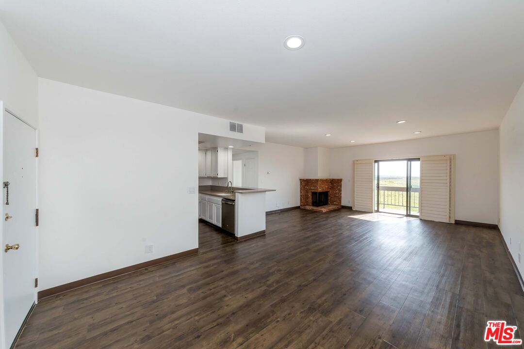 8180 Manitoba Street, Unit 248 Playa del Rey, CA 90293 - Photo 3 of 40 a view of empty room with wooden floor and kitchen
