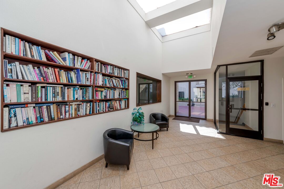 8180 Manitoba Street, Unit 248 Playa del Rey, CA 90293 - Photo 35 of 40 a living room with furniture and a book shelf