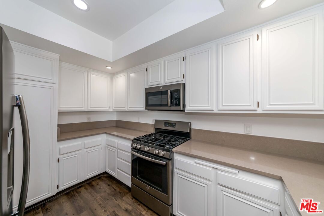 8180 Manitoba Street, Unit 248 Playa del Rey, CA 90293 - Photo 8 of 40 a kitchen with white cabinets and stainless steel appliances