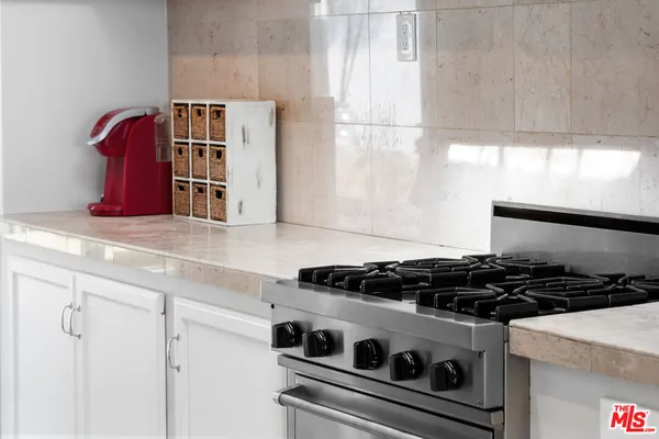 a close view of a stove a microwave and cabinets