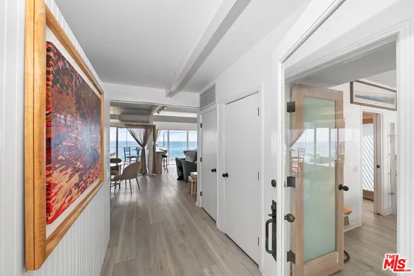 a hallway with wooden floor and furniture