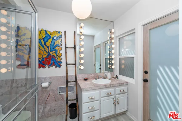 a bathroom with a sink a vanity and a mirror