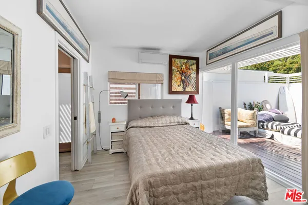 a bedroom with a bed couch and a window