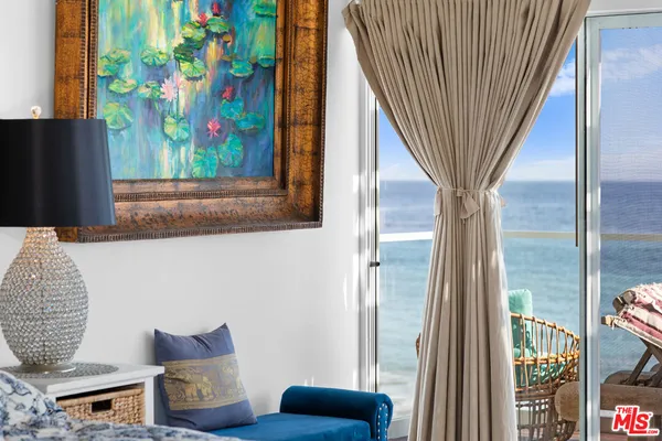 a view of a patio with table and chairs and potted plants