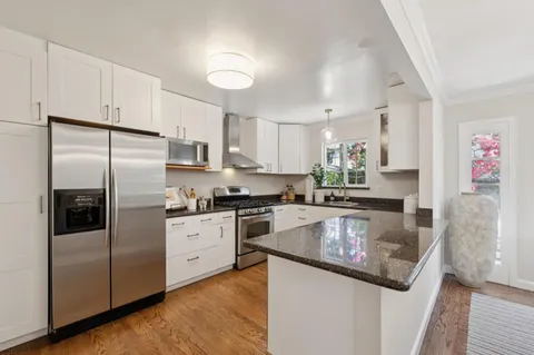 a kitchen with a sink stove top oven and cabinets