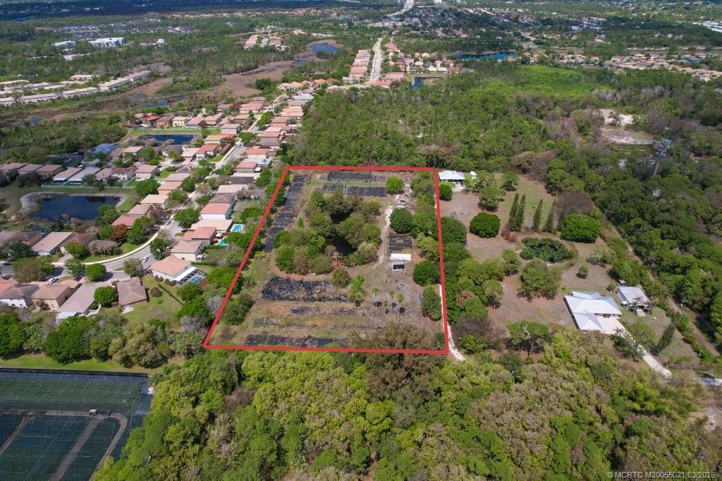 1005 Southeast Ponderosa Road Stuart, FL 34997 - Photo 4 of 8 an aerial view of residential houses with outdoor space