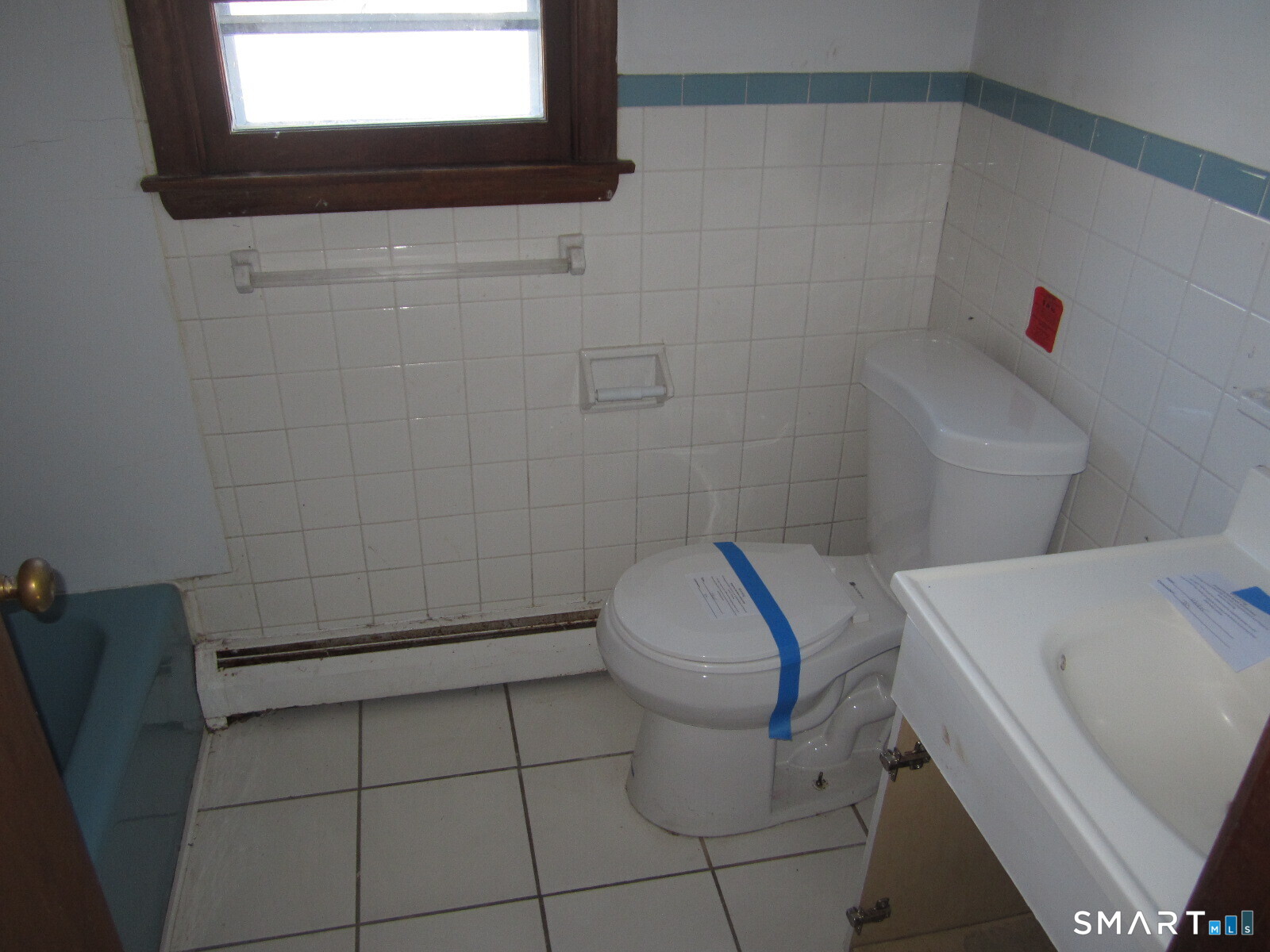 37 Graham Road East Hartford, CT 06118 - Photo 11 of 26 a white toilet sitting next to a bathroom sink