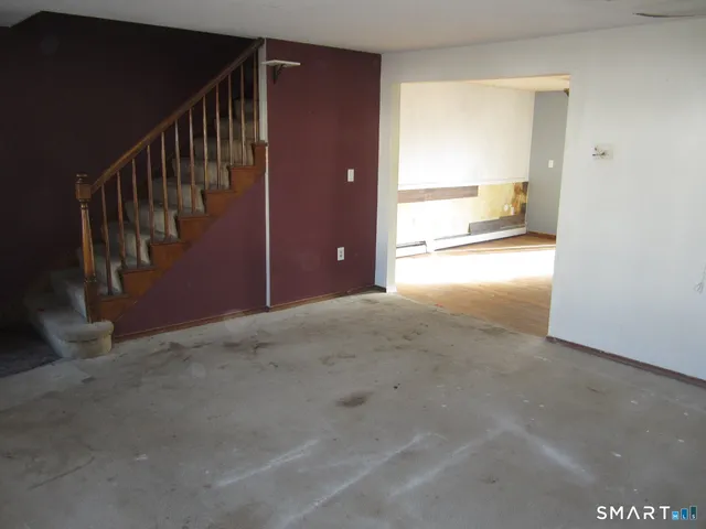 a view of hallway with wooden floor