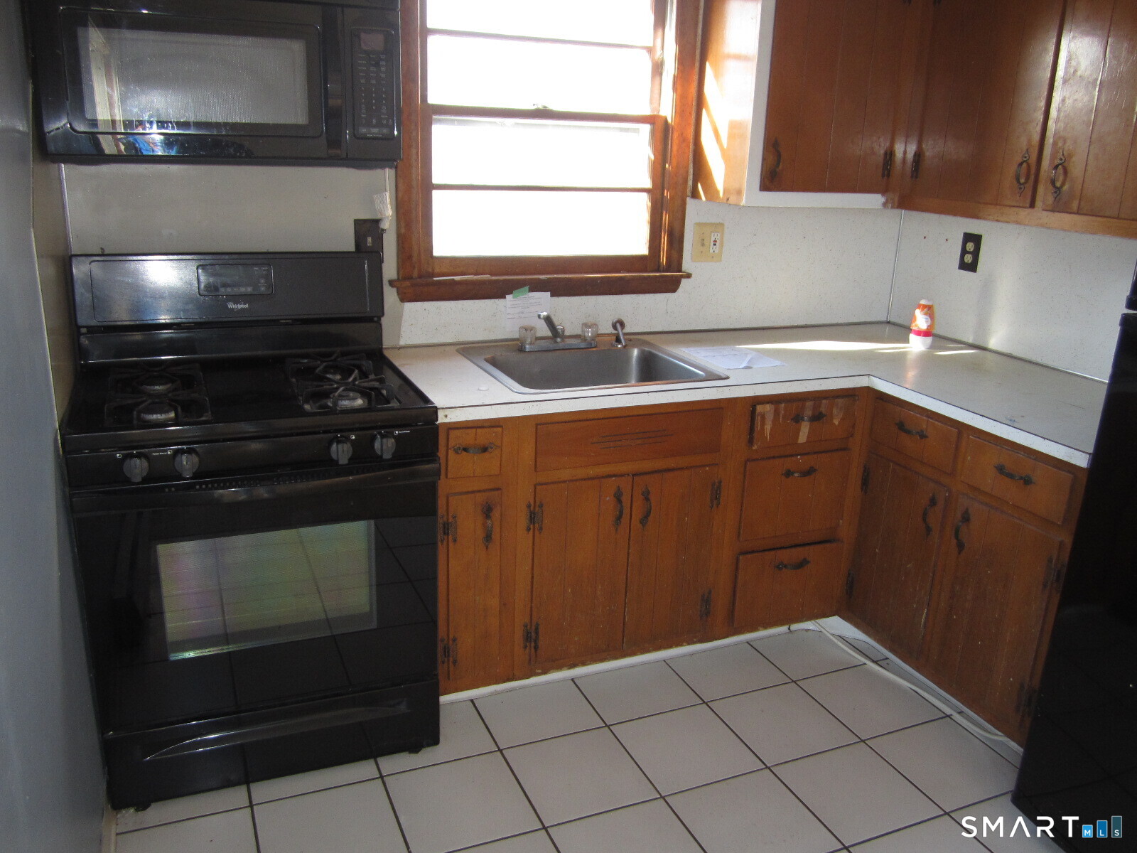 37 Graham Road East Hartford, CT 06118 - Photo 18 of 26 a kitchen with a sink stove and cabinets