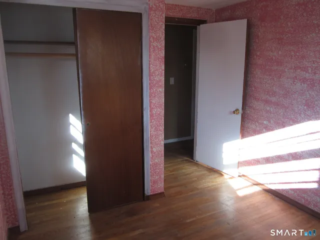 a view of an entryway door with wooden floor