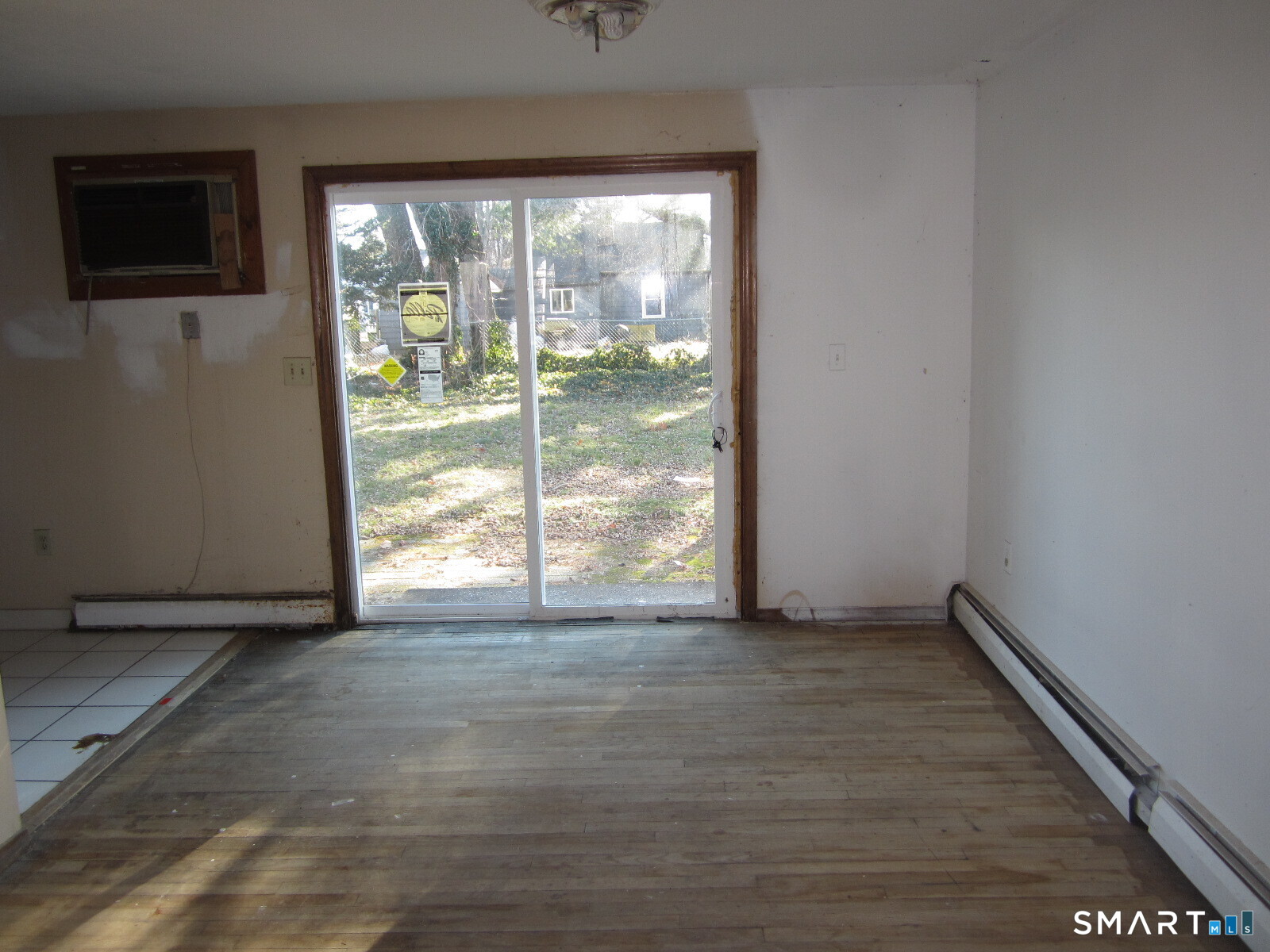 37 Graham Road East Hartford, CT 06118 - Photo 6 of 26 a view of an empty room with wooden floor and a window