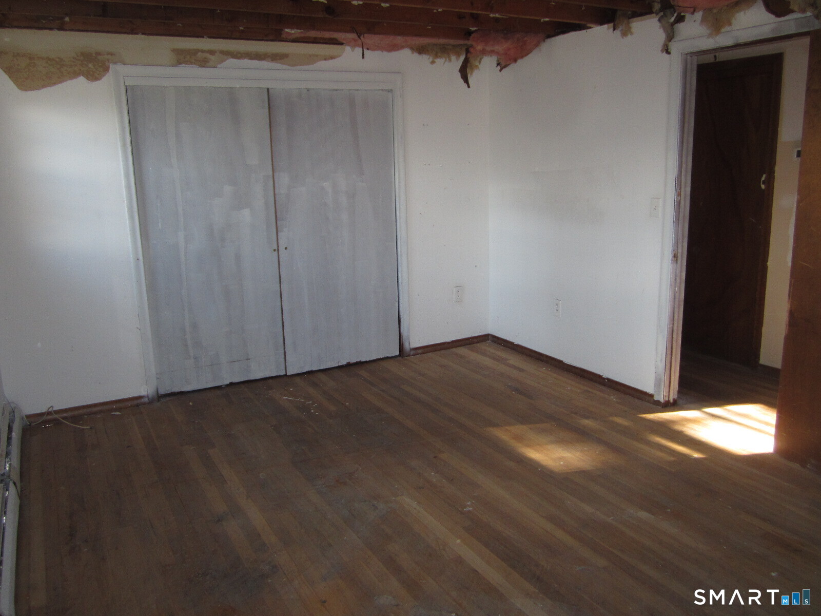 37 Graham Road East Hartford, CT 06118 - Photo 9 of 26 a view of an empty room with wooden floor and a window